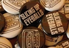 New at the merch table: Slicing Up Eyeballs’ cassette-themed buttons — plus stickers